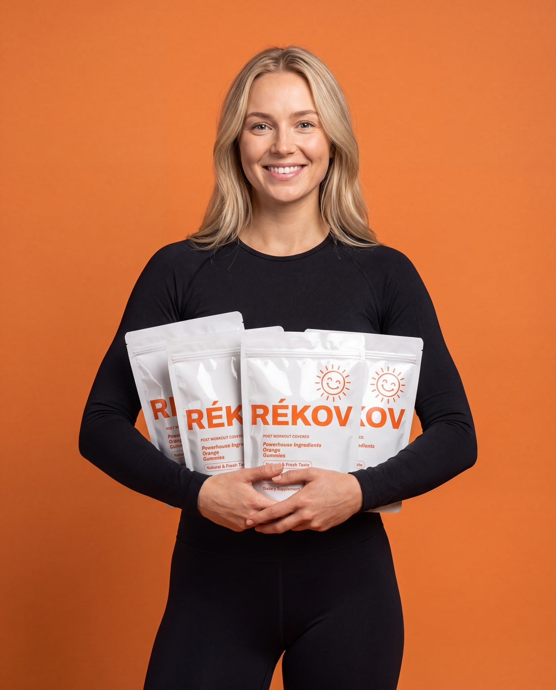 Athlete holding three Rékov Orange pouches